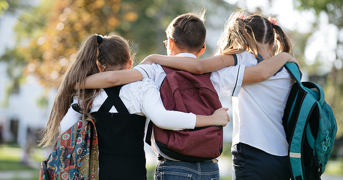 Three Students with arms around each other