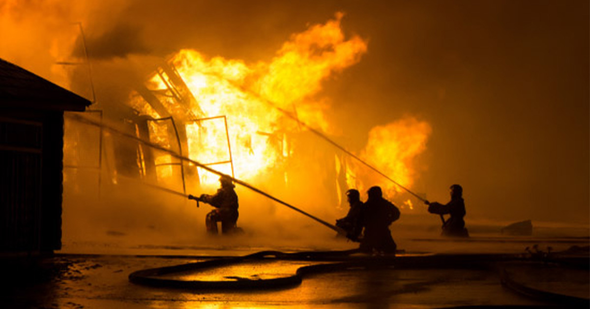 Four Firefighters Putting Out Large Fire, common causes of workplace fires